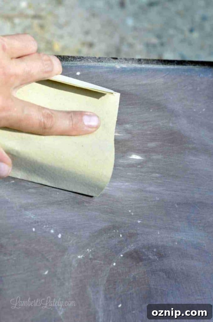 sanding a wood table.