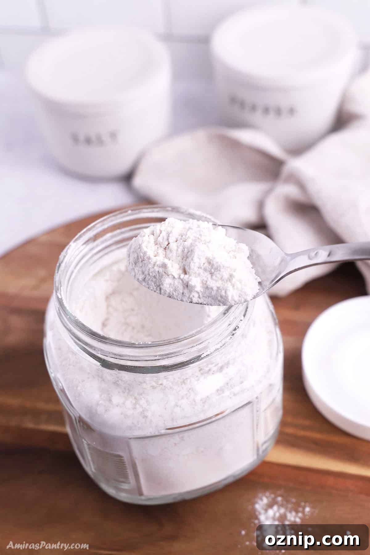 Homemade Bisquick Mix Without Shortening 2 Homemade Bisquick mix in a jar with a spoon.