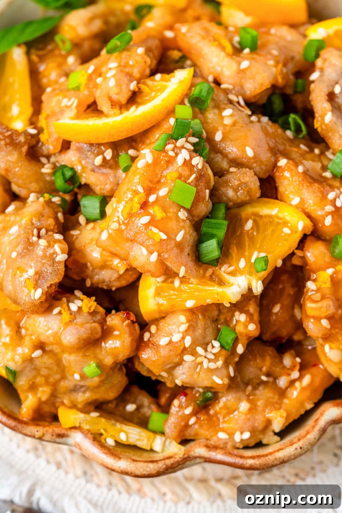 Golden pan-fried Orange Chicken tossed in a sticky-sweet citrus glaze. Fresh orange juice, lemon, soy, and a hint of ginger create a sweet, salty, and tangy dish.