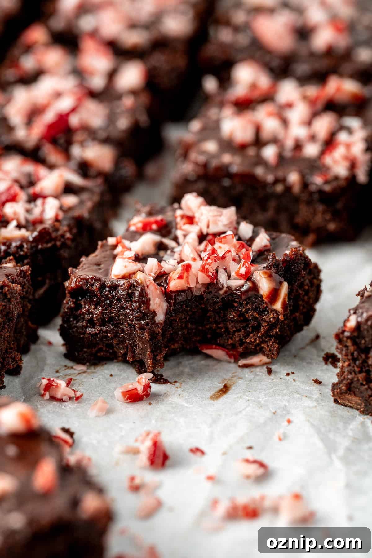 Close up of a chocolate peppermint brownie with a bite taken.