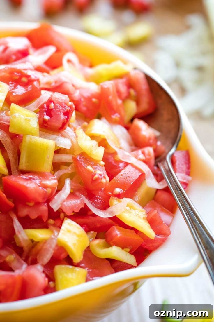Top 10 Recipes of 2021: Most Popular Dishes Revealed 13 Closeup of a large spoon dipped into tomato and onion salad to serve it.