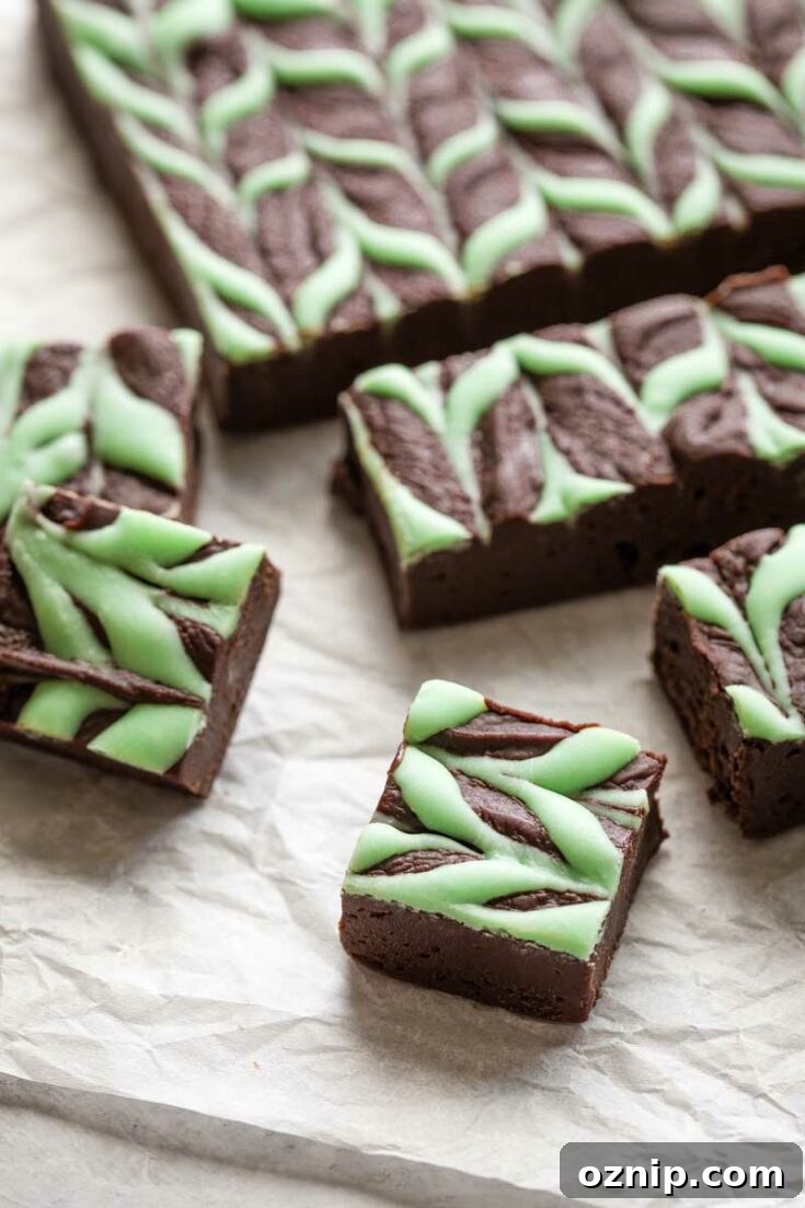 Top 10 Recipes of 2021: Most Popular Dishes Revealed 14 Closeup of one piece of mint chocolate fudge with others in background.