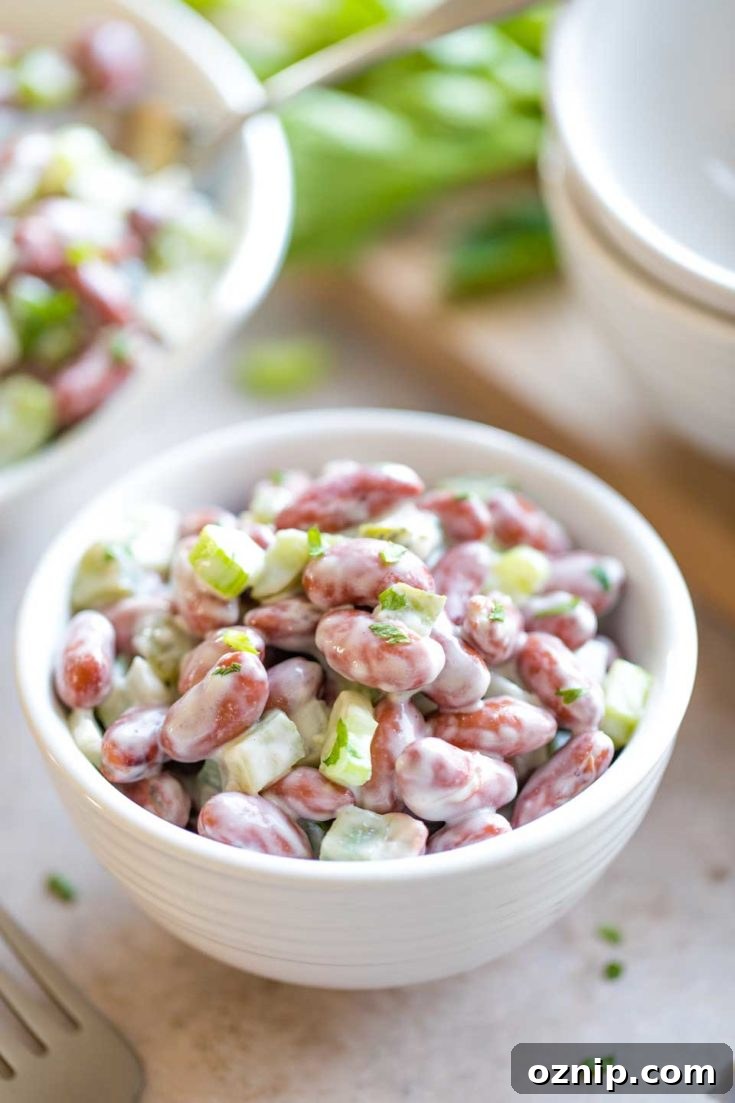 Top 10 Recipes of 2021: Most Popular Dishes Revealed 6 A small white bowl holding an individual portion of bean salad, with the full serving bowl in the background.