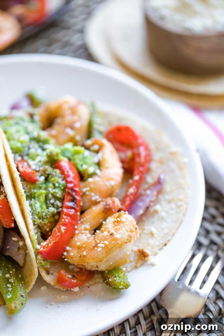 Top 10 Recipes of 2021: Most Popular Dishes Revealed 10 A plated shrimp fajita showing shrimp and peppers with guacamole nearby.