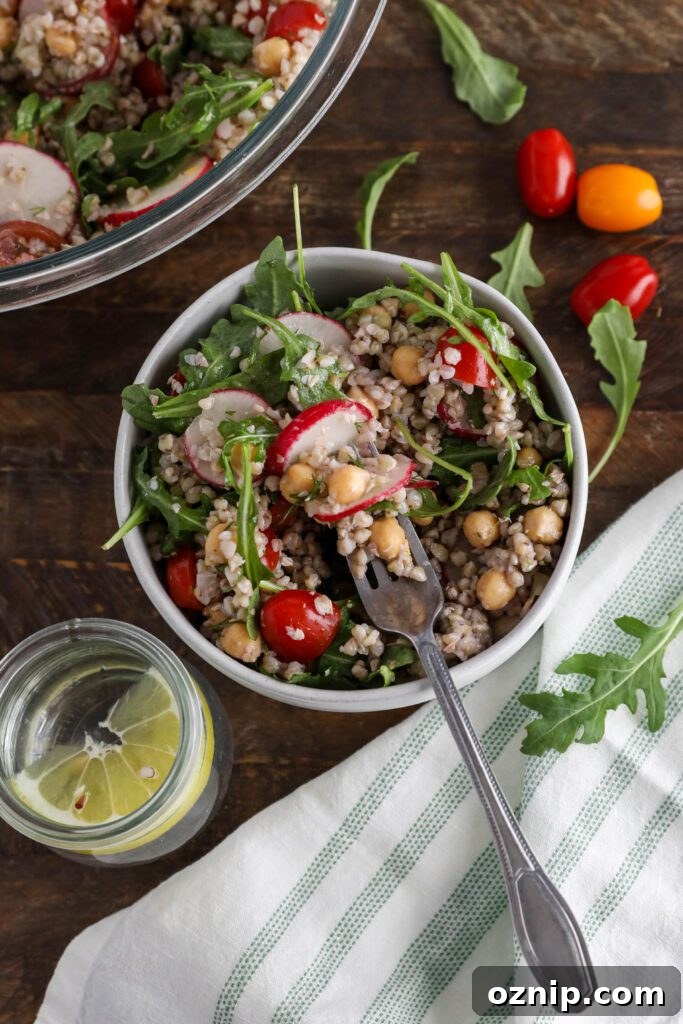 Spring Buckwheat Tabbouleh in bowl with arugula and cherry tomatoes on the side