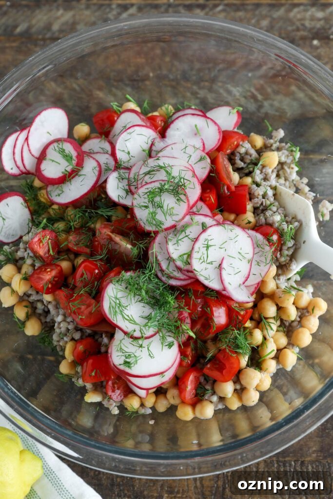 buckwheat, chickpeas, radishes, and tomatoes with dill in glass bowl 