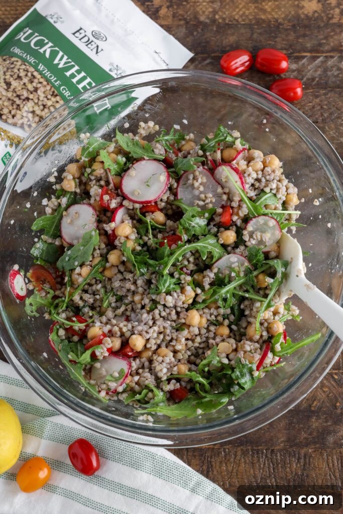 Spring Buckwheat Tabbouleh in bowl with arugula and cherry tomatoes on the side