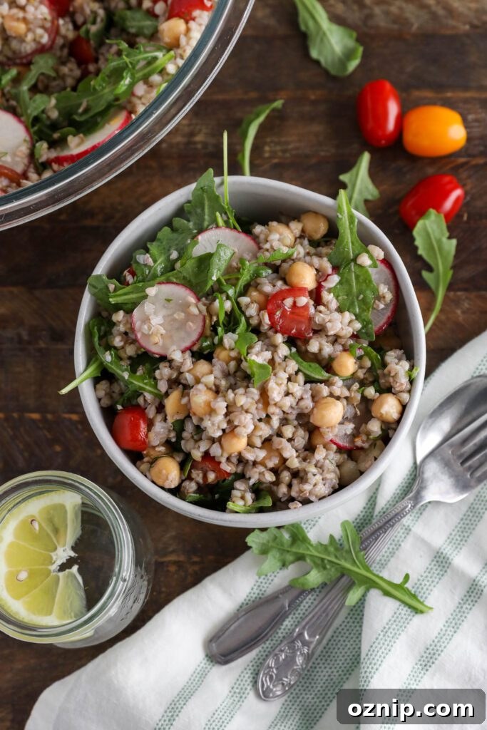 Spring Buckwheat Tabbouleh in bowl with arugula and cherry tomatoes on the side