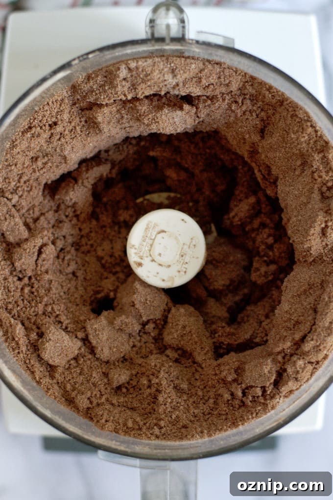 Double Peppermint Chocolate Cookie Recipe 7 double chocolate peppermint cookie dough looking like wet sand in the bowl of a food processor
