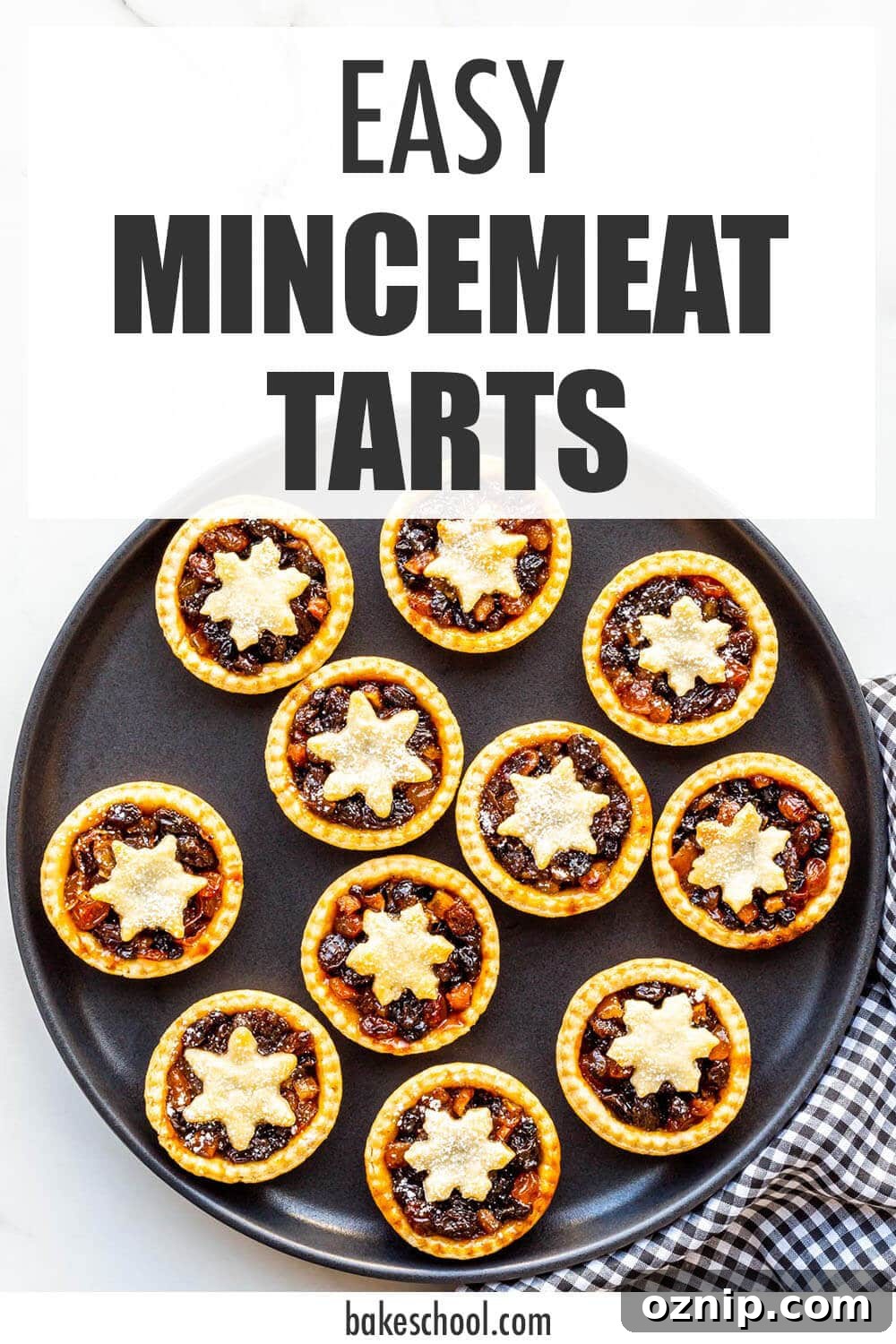 Homemade mincemeat tarts on a black plate, ready to be served.