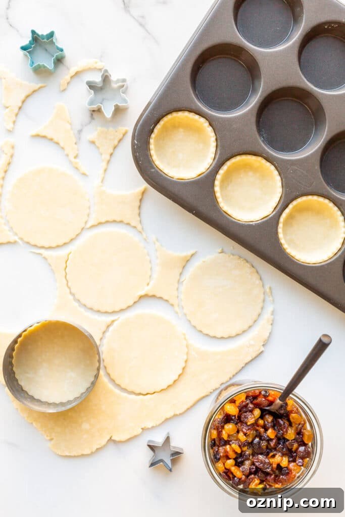 Assembling mince pies in muffin tins.