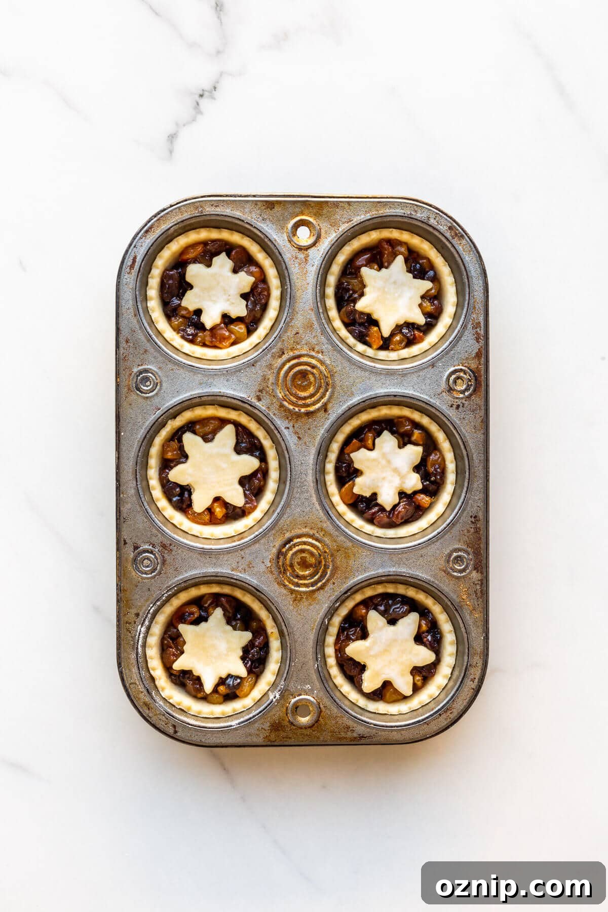 Mincemeat tarts before baking in a muffin tin.