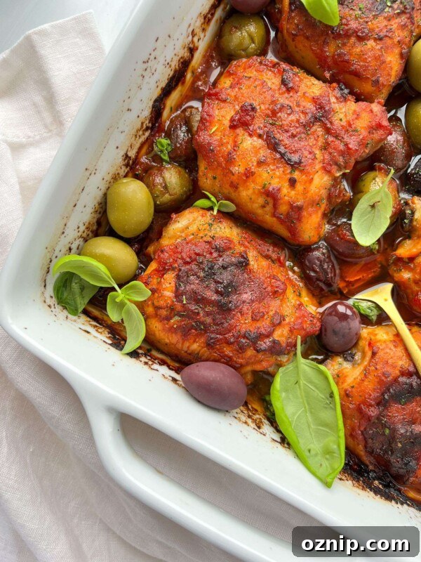 Oven-Baked Chicken with Pizza Sauce 3 Pizza Sauce Baked Chicken in a white baking dish with olives and basil