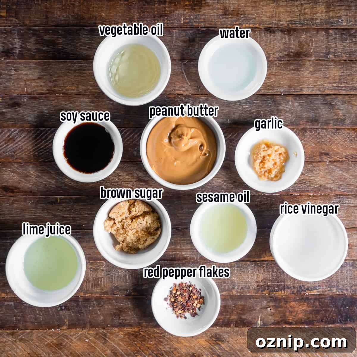 Thai peanut dressing ingredients including peanut butter, soy sauce and other items in small bowls with text.