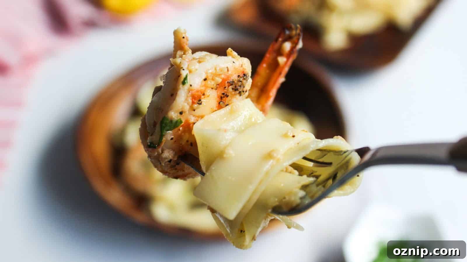 A bowl of shrimp pasta with lemon and parsley.