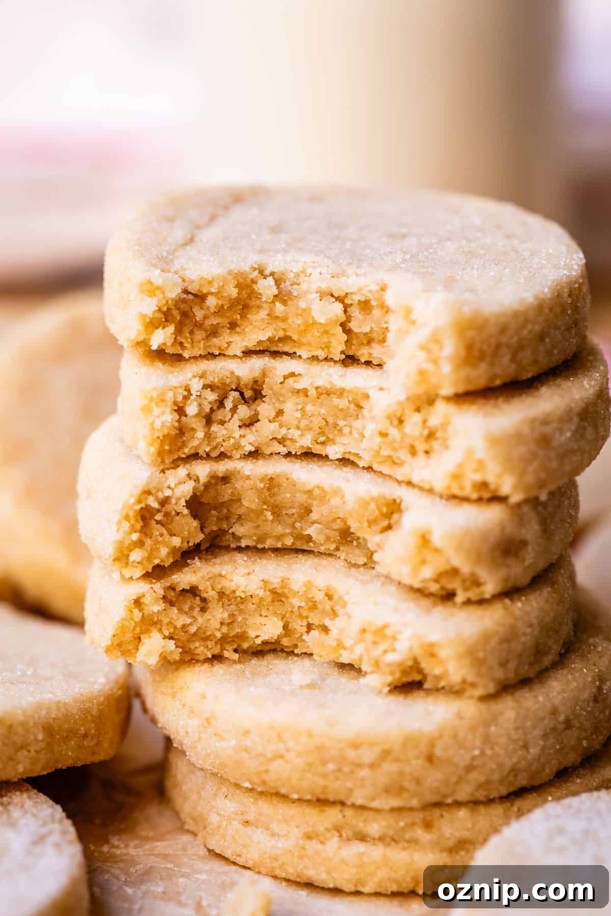Classic Homemade Buttery Shortbread Cookies 7 stack of shortbread cookies each with a bite taken out to show the center.