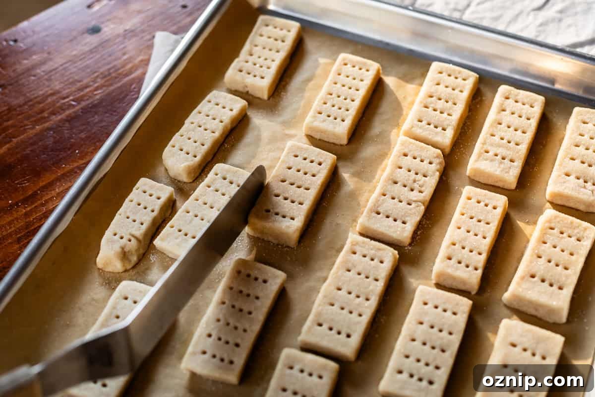 Classic Homemade Buttery Shortbread Cookies 13 tapping the edge of almost totally baked cookies for cleaner sides and edges.
