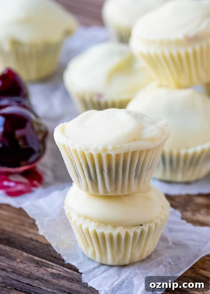 Bite sized creamy white chocolate cups filled with crushed biscuit and cherries - a simple 3-ingredient treat!