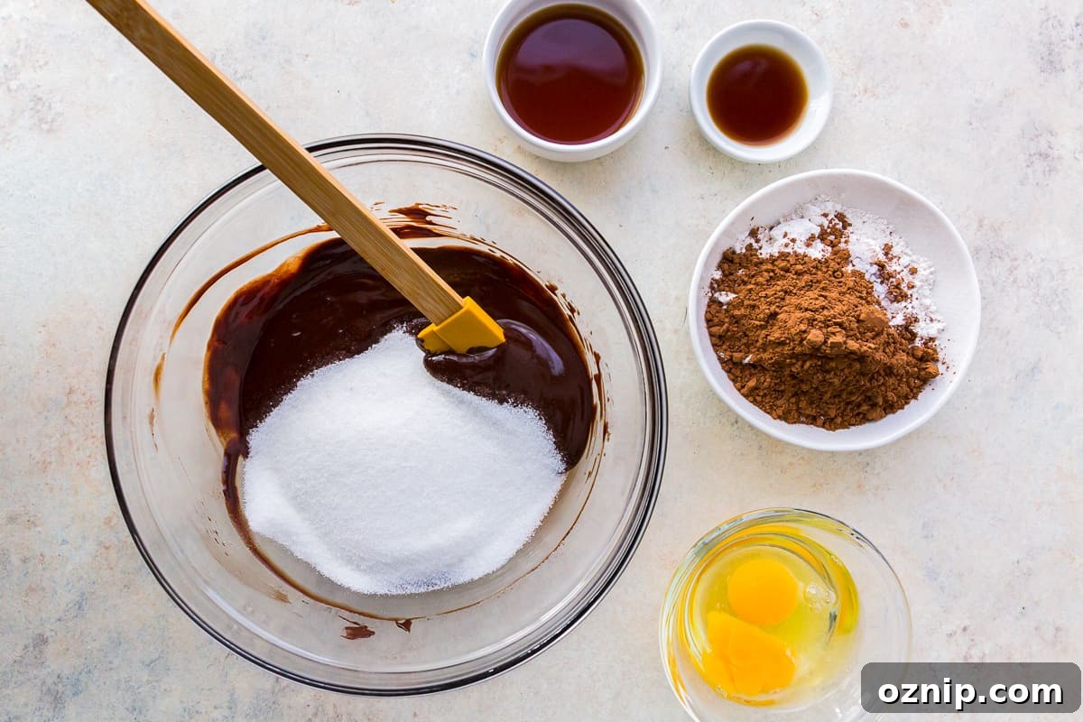 sugar and chocolate mixture in a glass bowl with a spatula