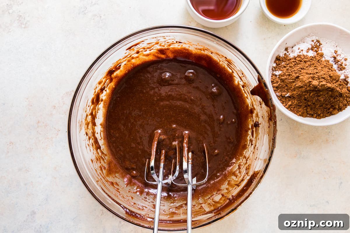 brownie batter in a glass bowl with beaters