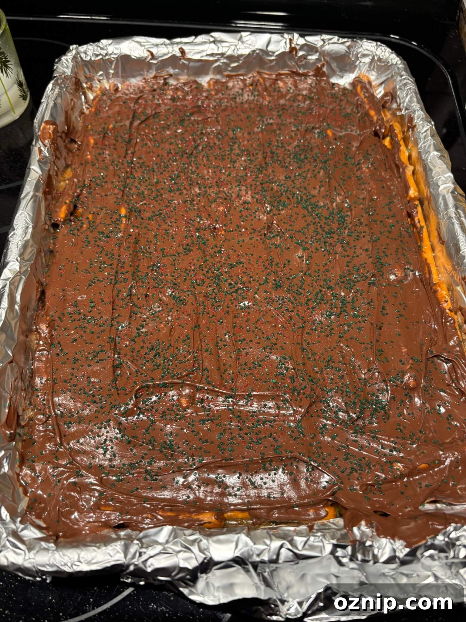 Gluten-Free Christmas Bark Recipe 8 Melted chocolate spread over gluten-free Christmas bark