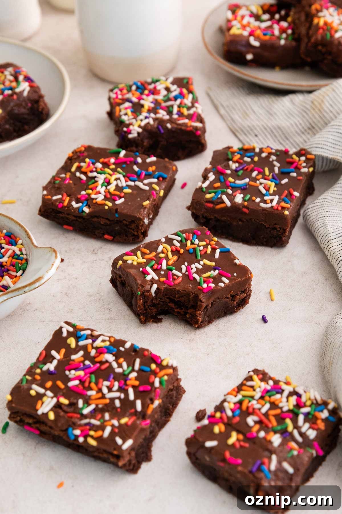 Fudgy Gluten-Free Birthday Brownies Recipe 7 birthday brownies on a counter with a bite missing from one.
