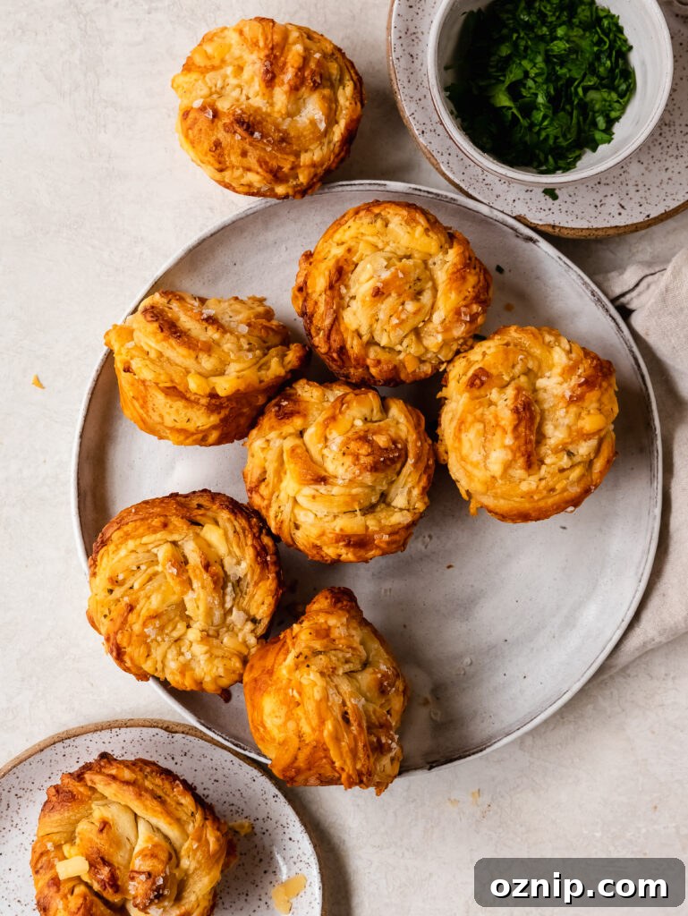 Twisted garlic cheese rolls on a baking sheet