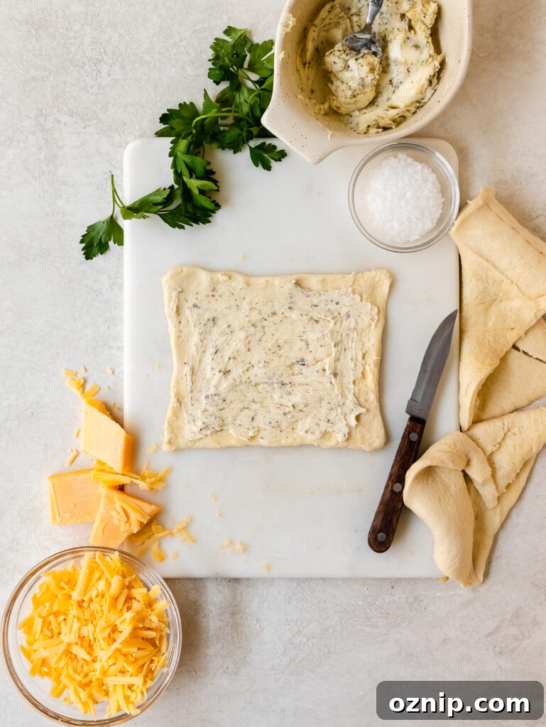 Spreading garlic butter and cheese