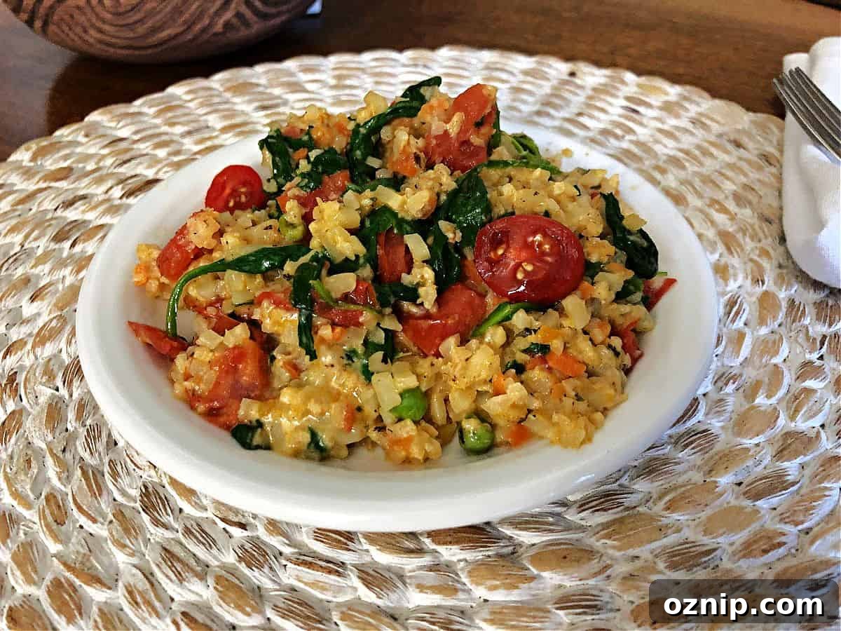 cheesy cauliflower rice with spinach and tomatoes