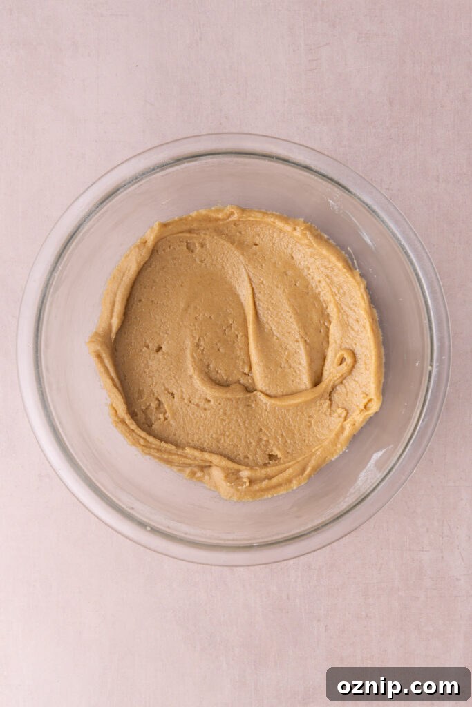 Buttery Crunch Cookies: Chewy Centers, Crispy Edges 8 Easy cookie dough made with brown butter in a glass mixing bowl.