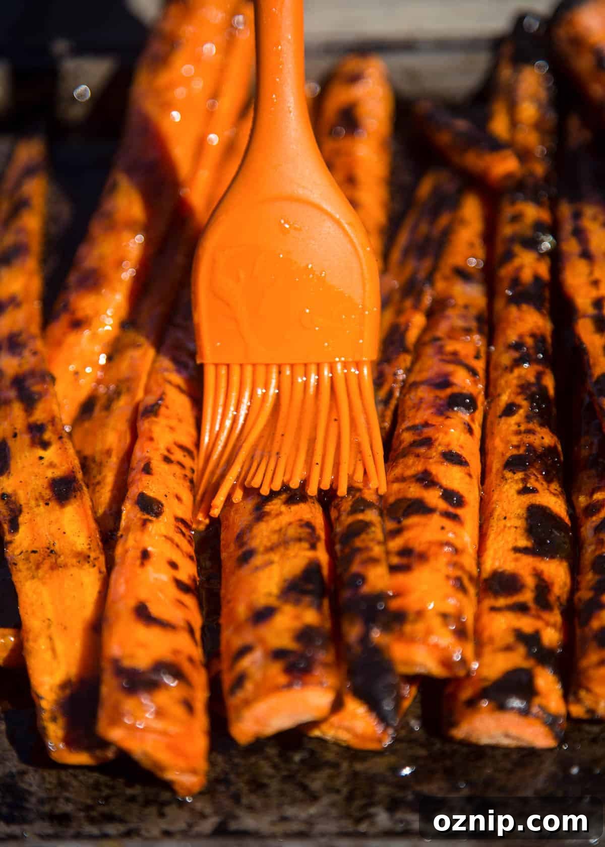 Drizzling grilled carrots with a sweet glaze