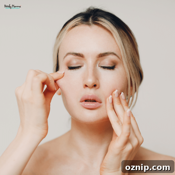 At Home Facial Exercises to Firm Skin and Smooth Fine Lines 2 A woman with fair skin and blonde hair gently massaging her face with her fingers, practicing a facial exercise for skin firming.