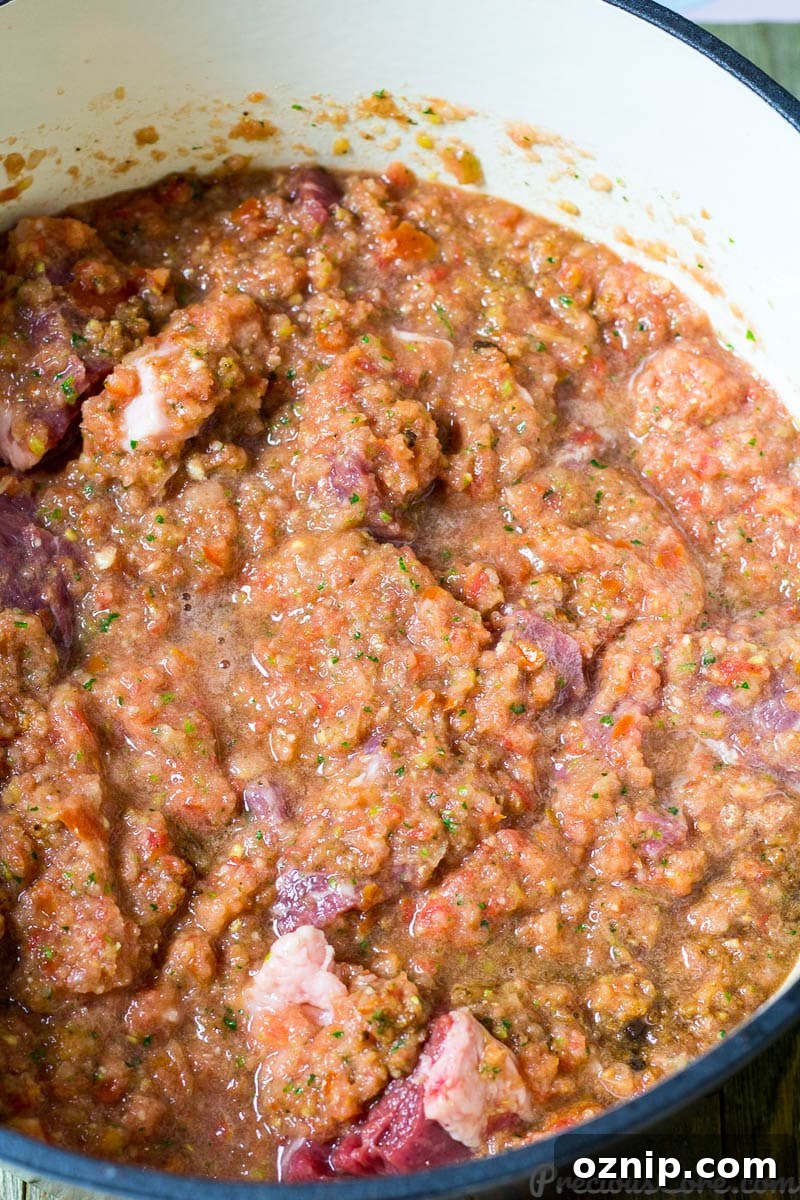 Beef and vegetable mixture in a pot.
