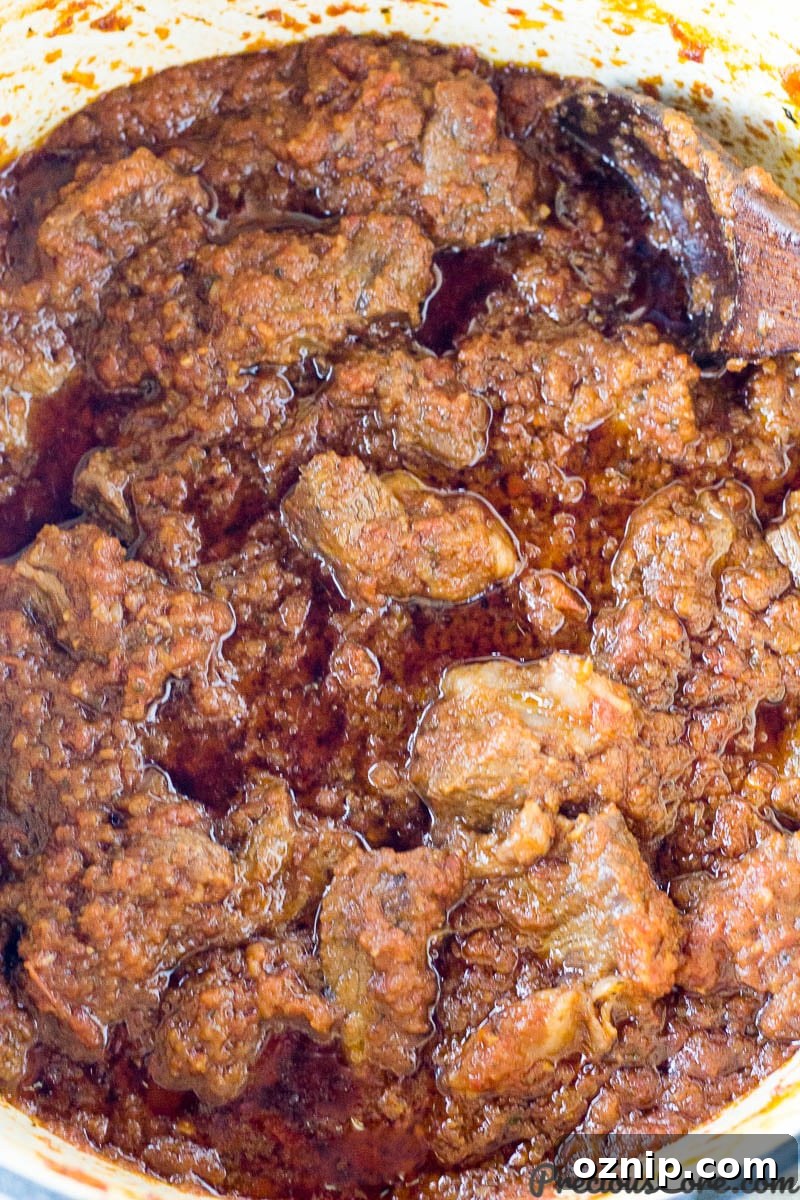 Wooden spoon in a pot of African Beef Stew.