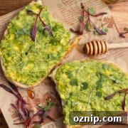 This is a square picture of two avocado toasts.