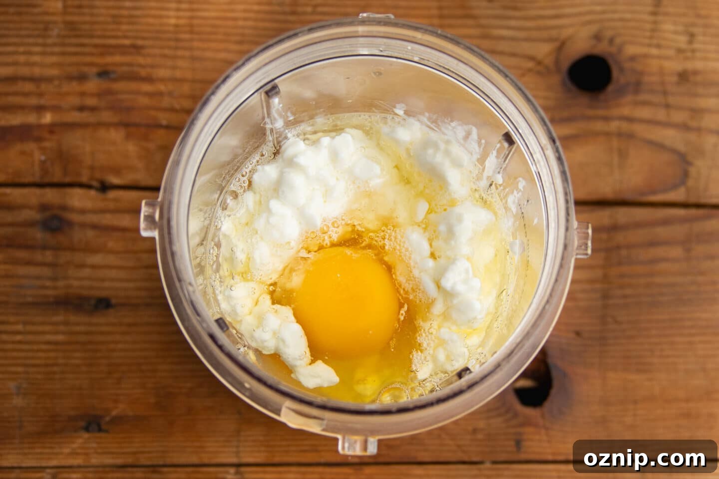 This is a picture of a blender with cottage cheese and eggs.