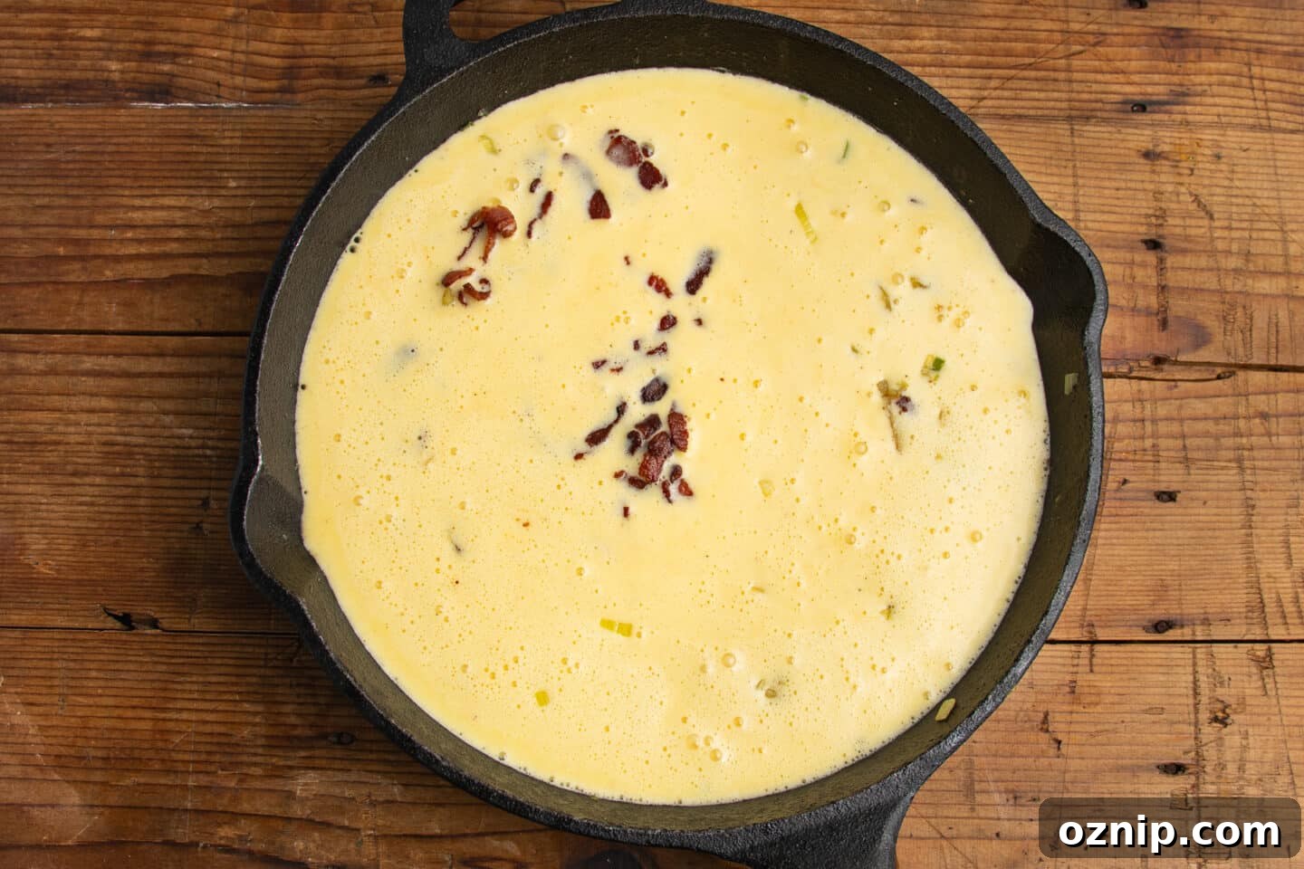 This is a picture of the egg mixture being added to the skillet.
