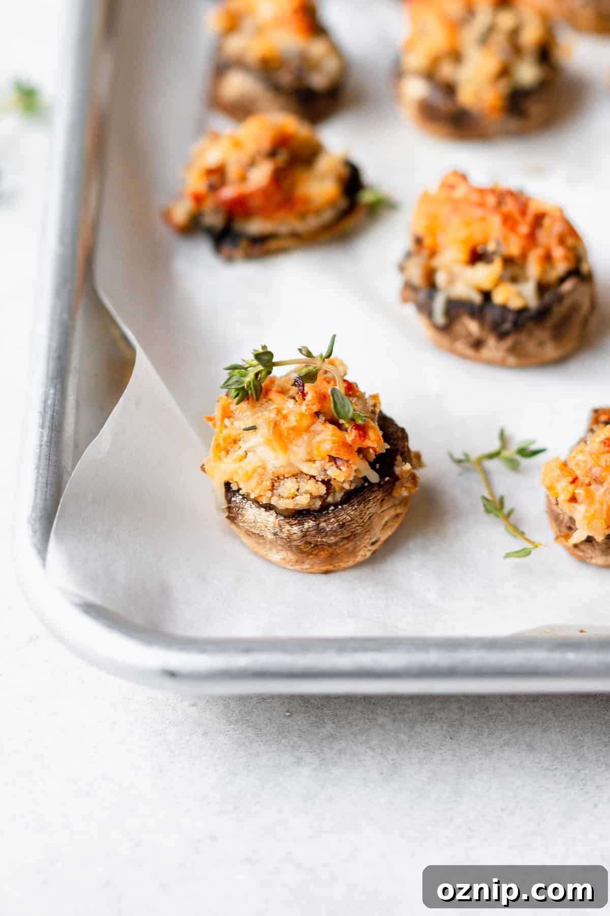 cream cheese stuffed mushrooms on a baking tray
