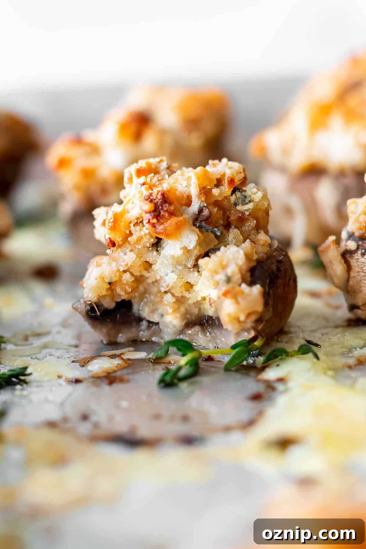 cream cheese stuffed mushroom with a bite taken out of it