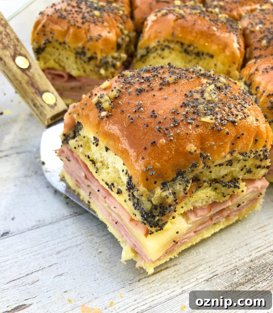 Homemade Ham and Cheese Sliders Recipe for Game Day 5 Baked hawaiian ham and cheese sliders on a spatula