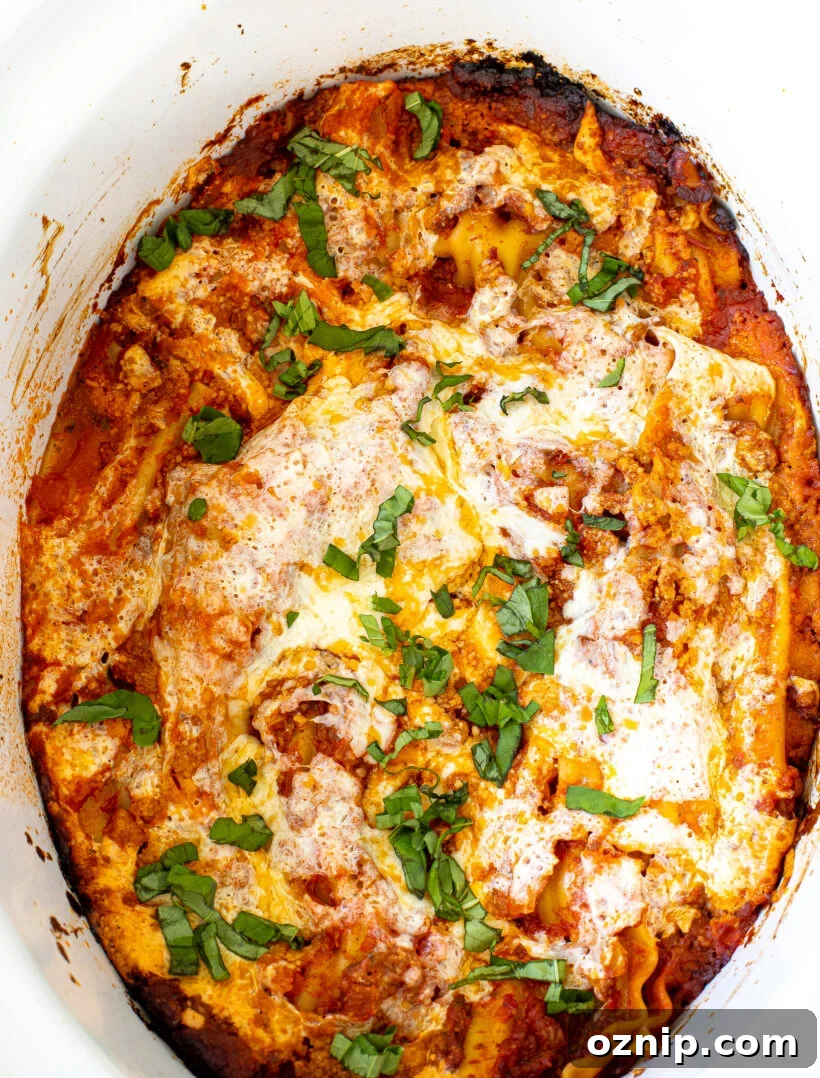 Slow Cooker Lasagna Recipe with Rich Meat Sauce 2 Top down view of slow cooker lasagna in a white crockpot liner.