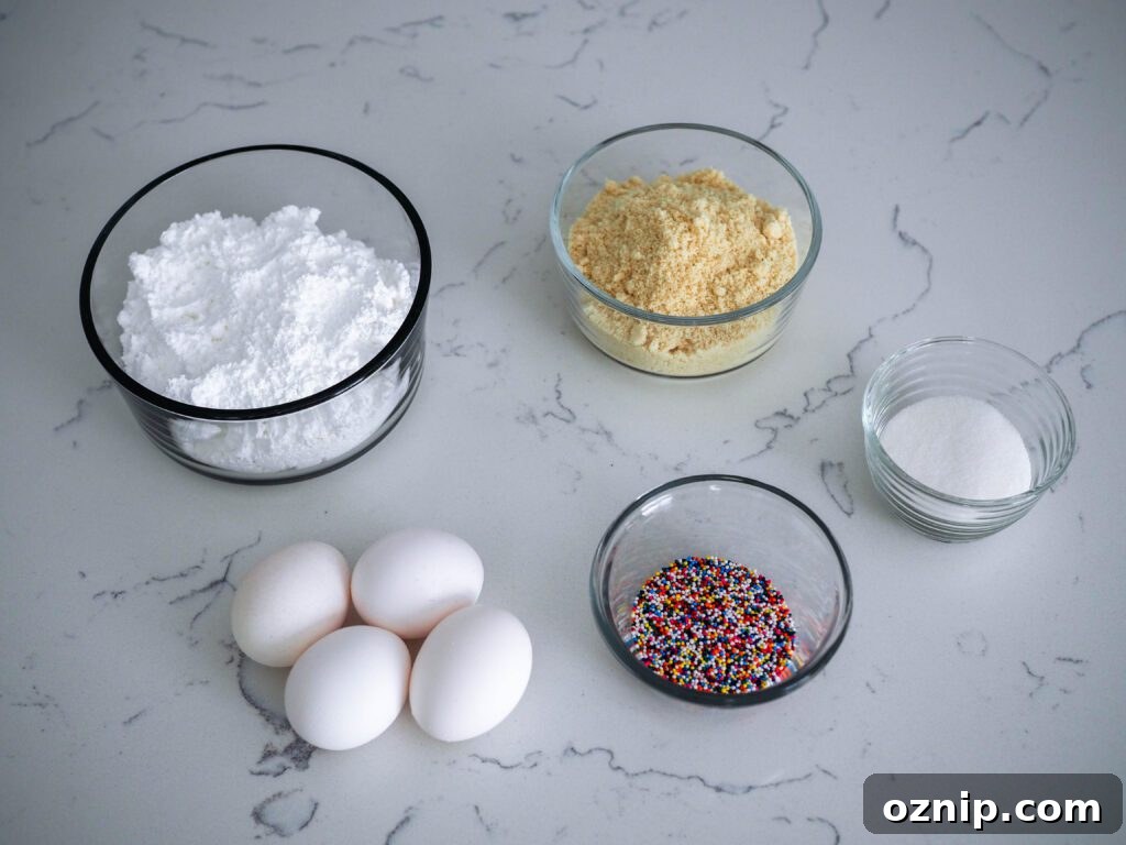 Eggs, powdered sugar, almond flour, granulated sugar, and rainbow nonpareil sprinkles are all you need to make birthday cake macarons.