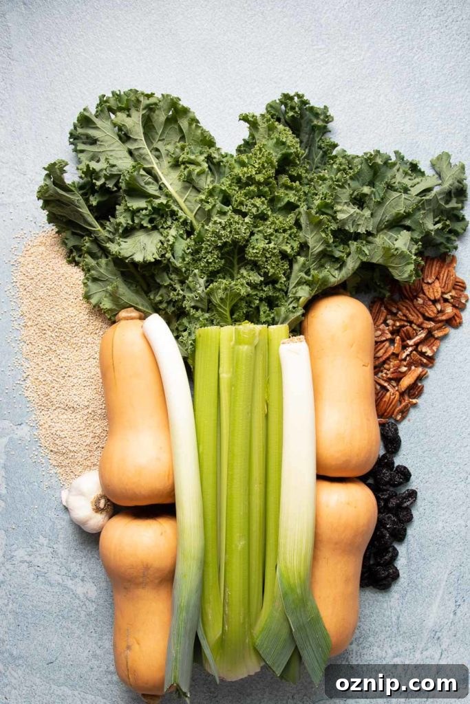 Roasted Stuffed Butternut Squash Recipe 3 Butternut squash, kale, quinoa, celery, leeks, pecans, garlic and dried cherries displayed together.