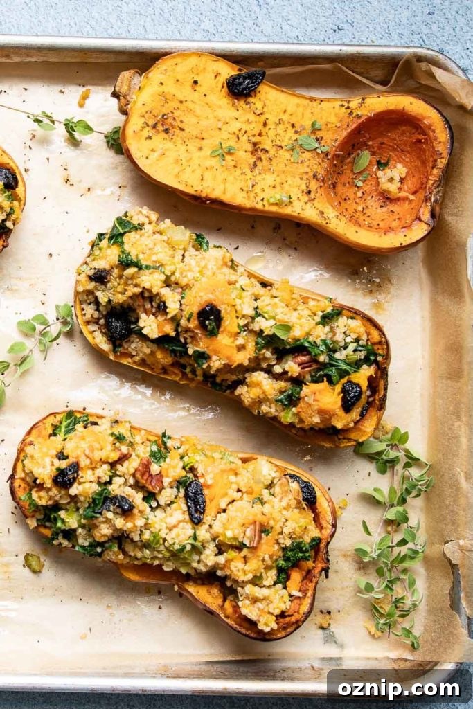 Roasted Stuffed Butternut Squash Recipe 10 A baking tray with roasted butternut squash, some stuffed with quinoa.