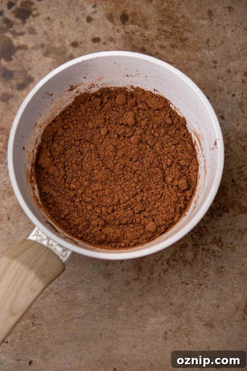 Dry ingredients in a pot inclusing cocoa powder and sugar before mixing.