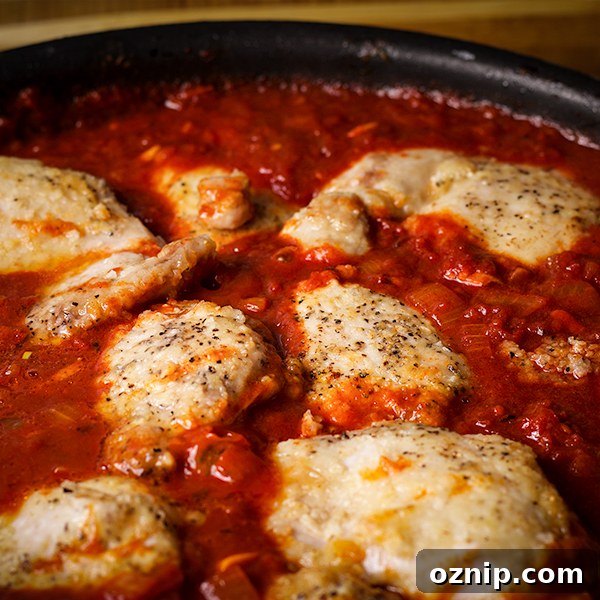 A pan of Chicken Paprikash cooking on the stovetop.