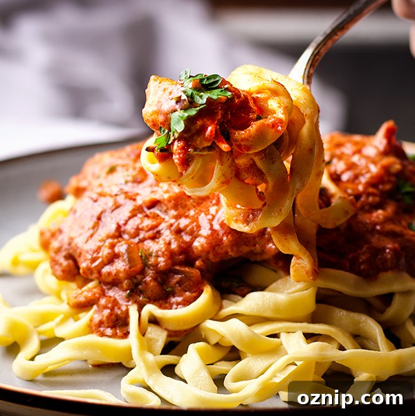 Taking a bite of Chicken Paprikash with Buttered Egg Noodles.