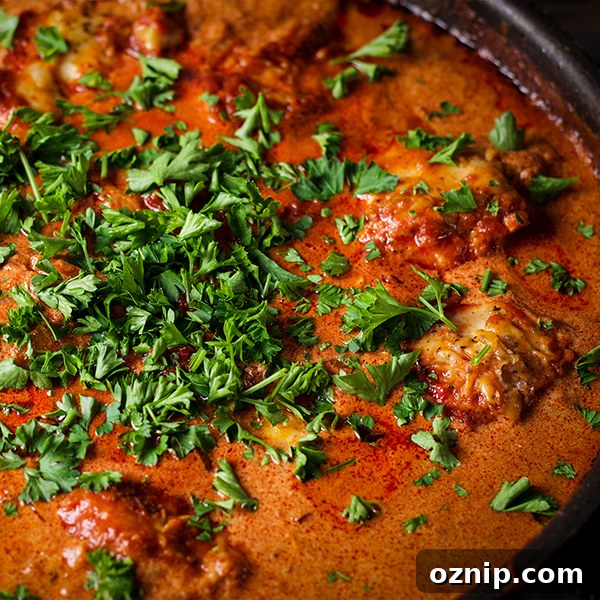 A pan of Chicken Paprikash sprinkled with chopped, fresh parsley.