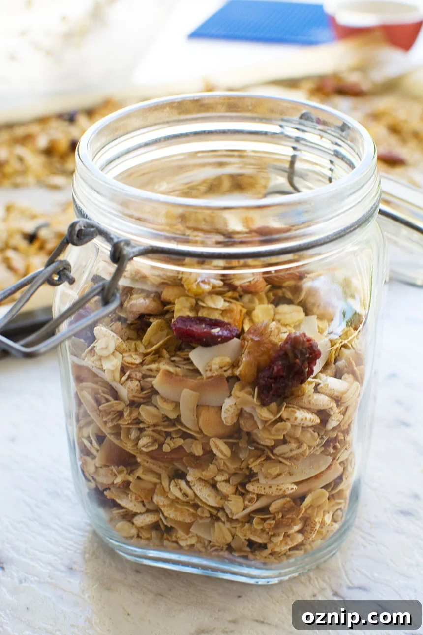 Homemade Low Sugar Granola: Crunchy Morning Recipe 7 A closeup of homemade granola in a glass container that's open