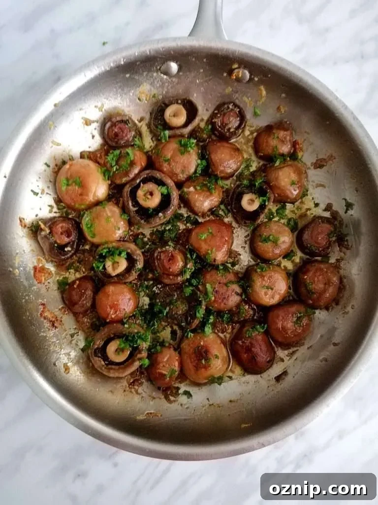 Top 7 Thanksgiving Side Dishes to Make This Year 7 garlic butter mushrooms in skillet with parsley